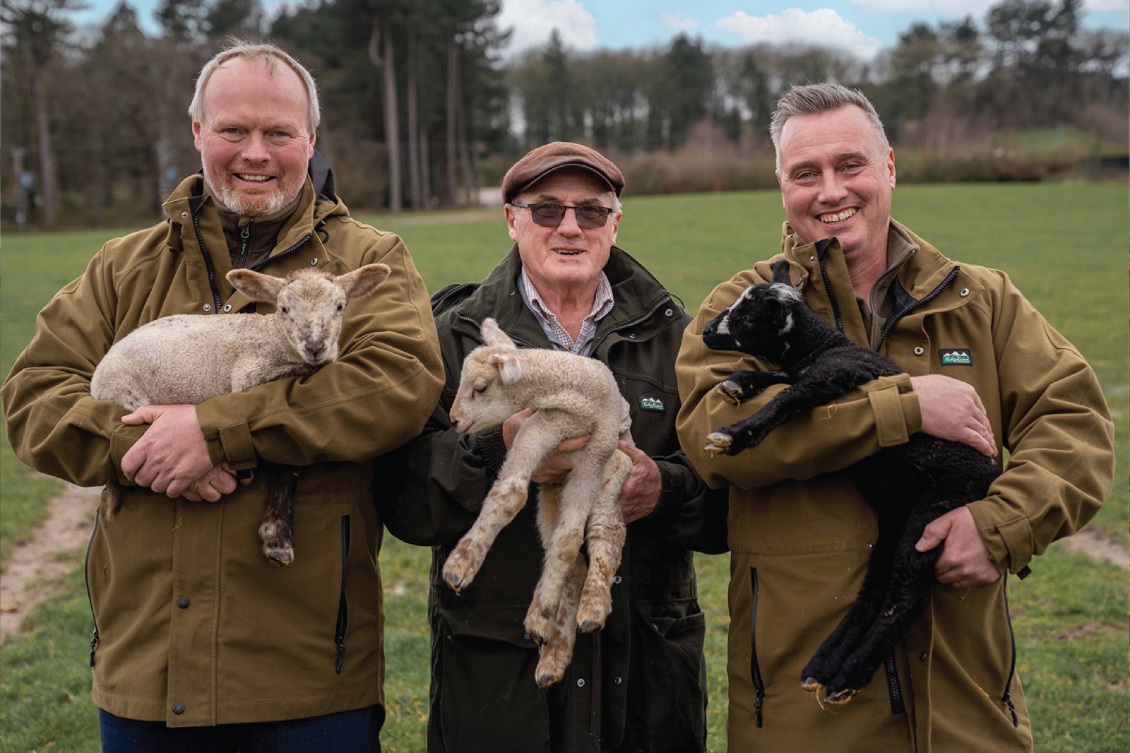 Our farmers holding lambs in Cannon Hall park