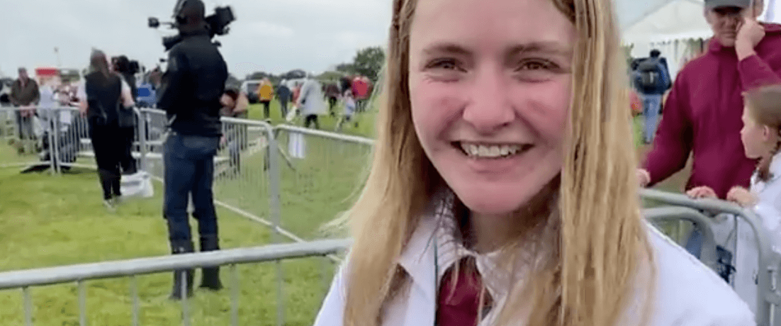 Photo of a show ground and a girl in a white coat