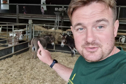 Photo of Dale in the donkey pen at Cannon Hall farm