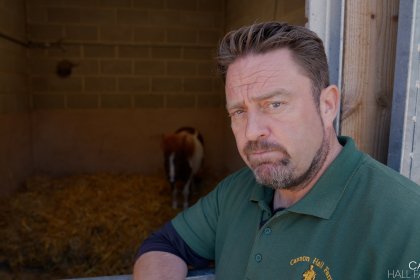 Photo of Farmer Daryl with a Shetland pony in an enclosure