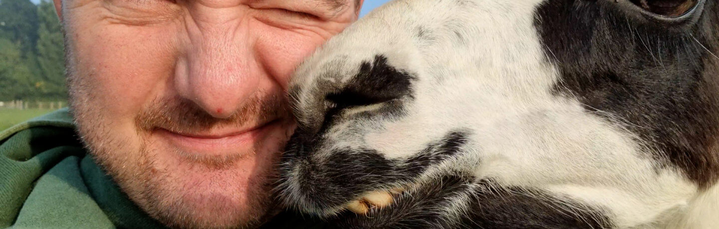 Photo of Farmer Alex with a llama