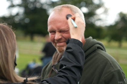 Photo of Rob Nicholson having make up applied before filming