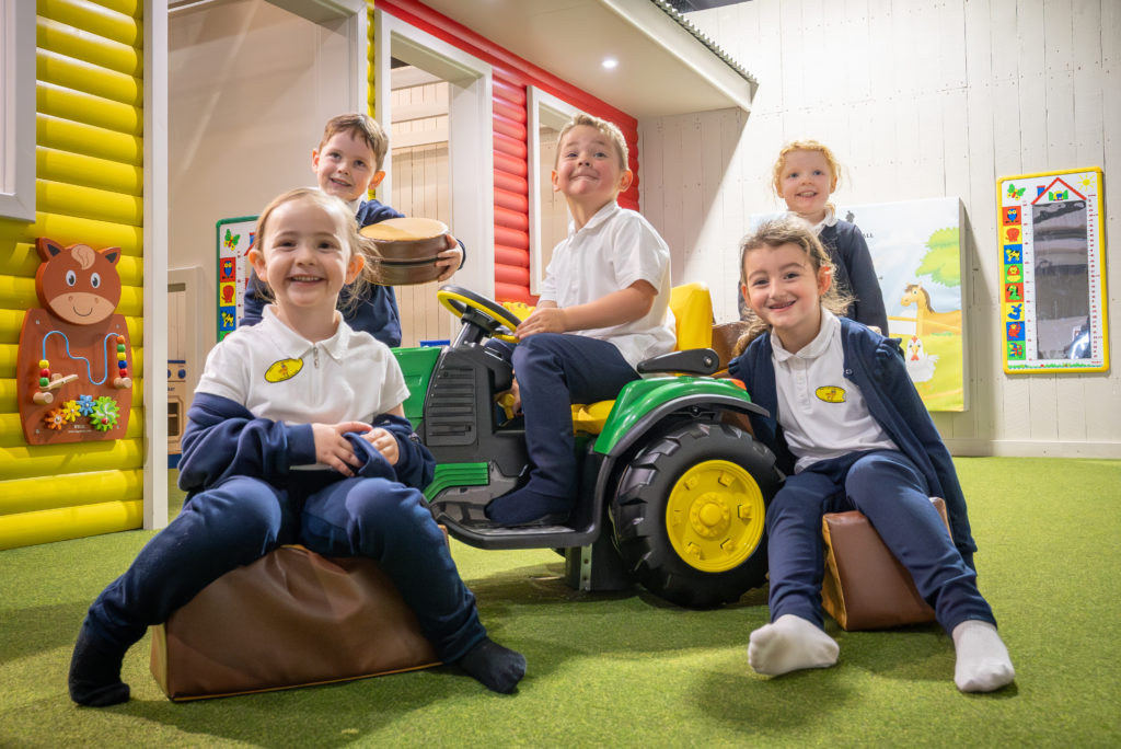 children playing on toy tractor